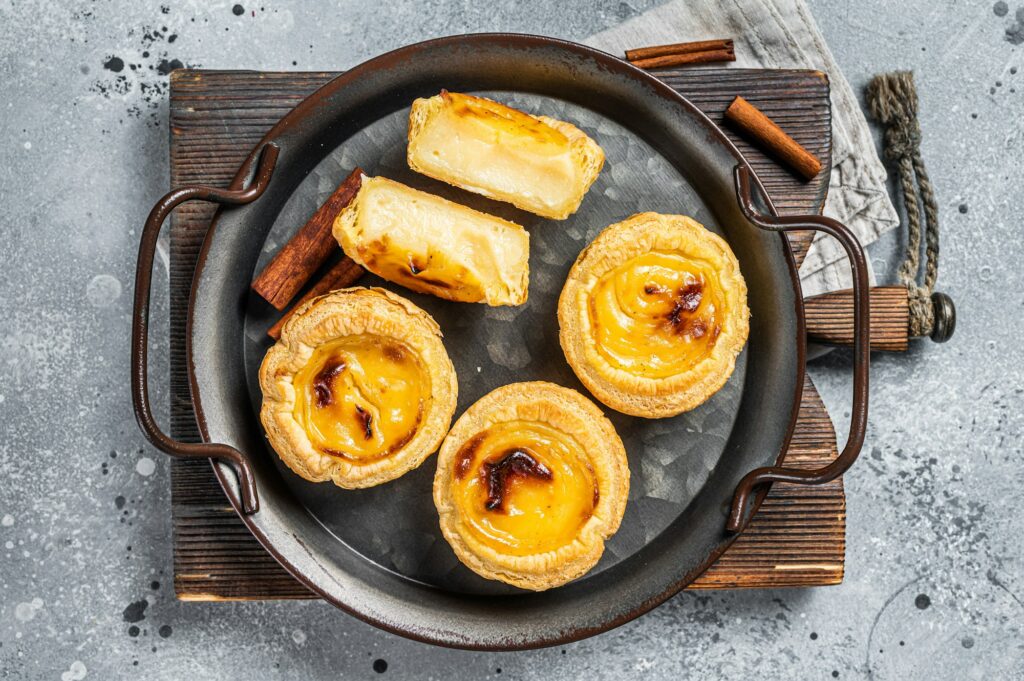 Pastel de nata traditional Portuguese egg custard tart. Gray background. Top view