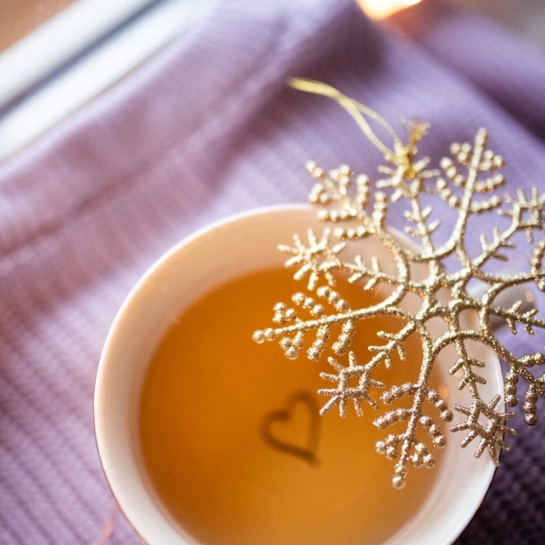 a cup of tea with a snowflake decoration in it